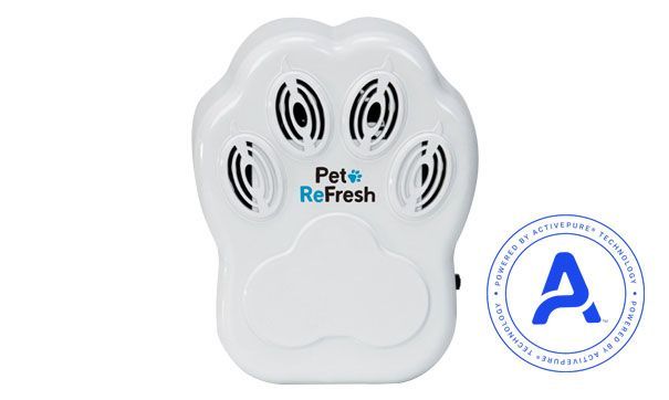 Woman in straw hat smiles, holding wine glass near a lake.