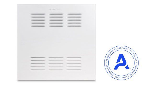 Woman in straw hat smiles, holding wine glass near a lake.