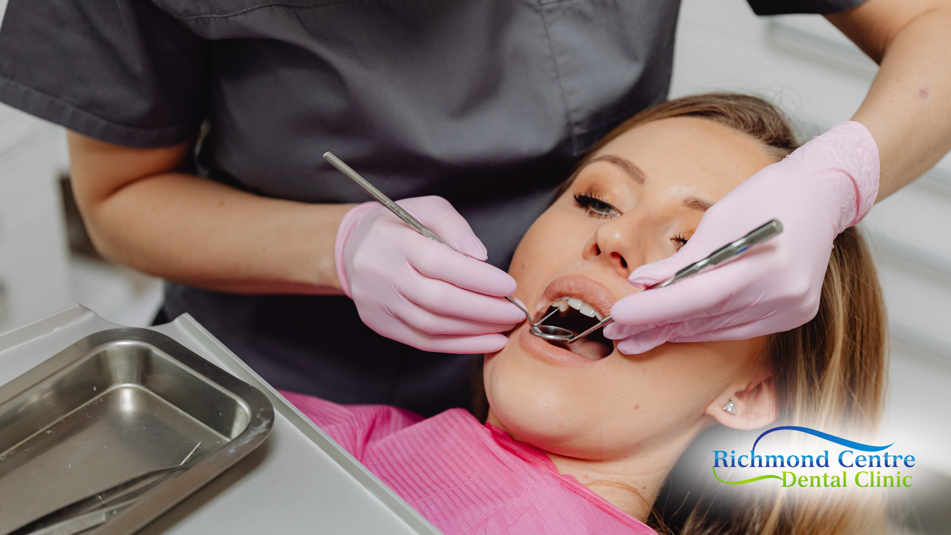 Dentist examining a patient's teeth with dental tools in a clinic.