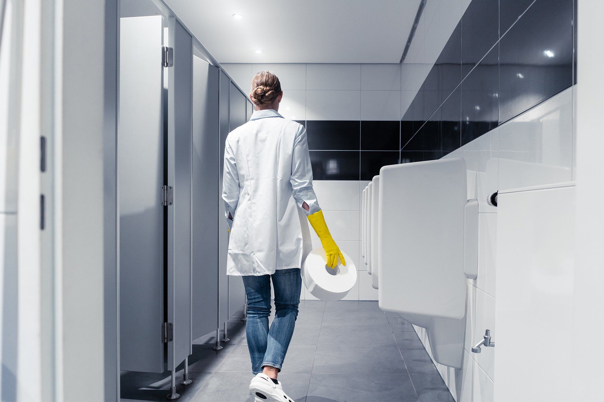 Janitor Woman Changing Paper in Toilet