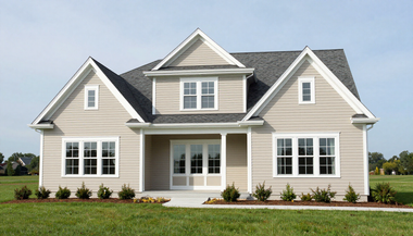 Suburban beige house with white trim, front porch, and manicured lawn
