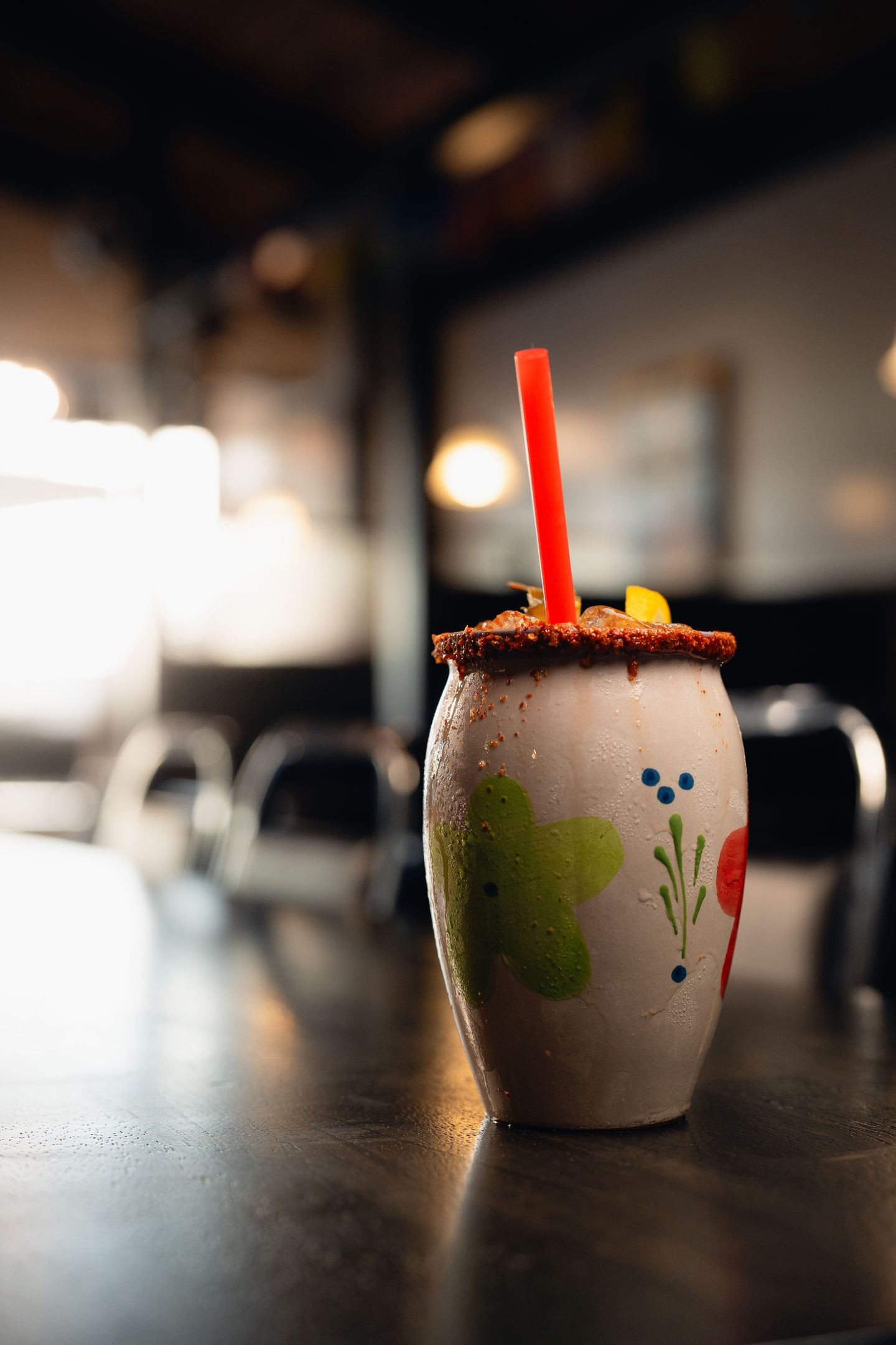 A drink with a straw in it is sitting on a table.