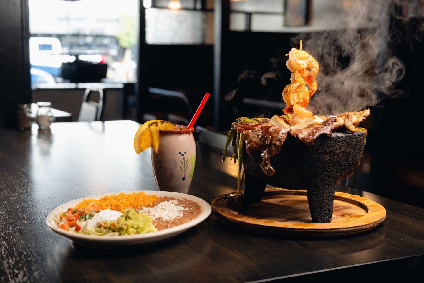 There is a plate of food and a drink on the table.