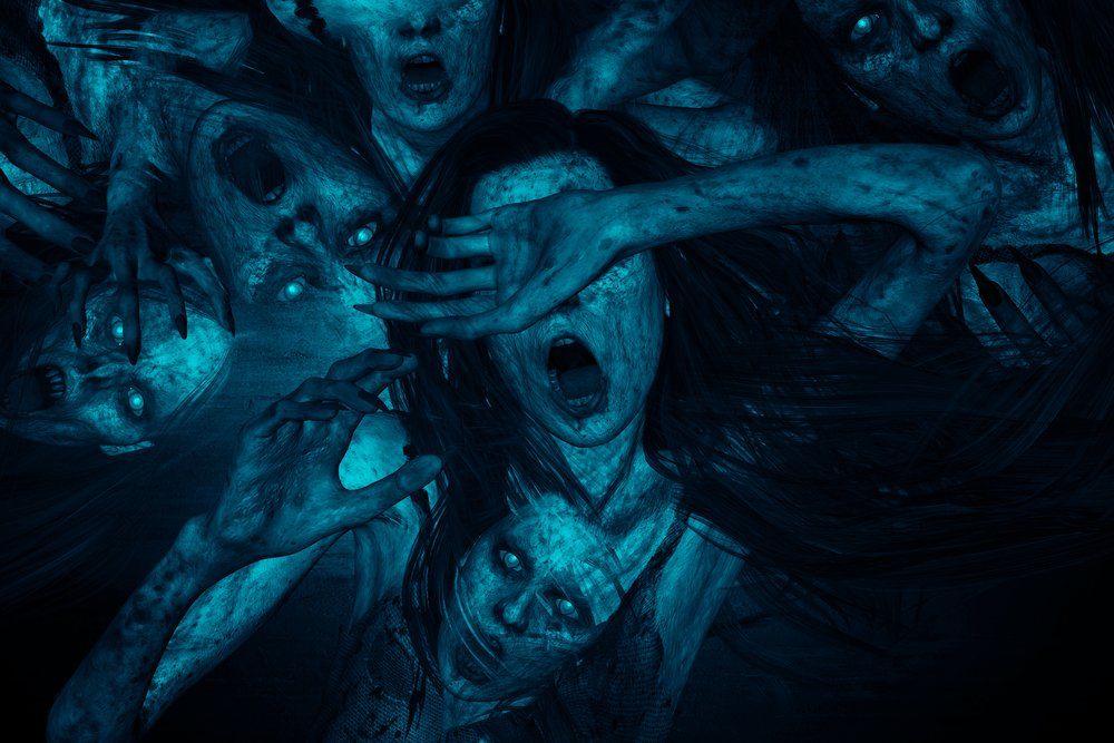 Group of ghostly figures with glowing blue skin, screaming and reaching out.