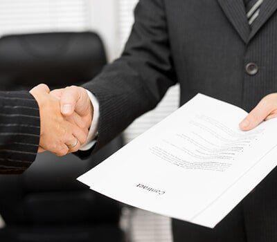 Lawyer with document in his handshaking with the client - Document Signing in Champaign - Urban, IL