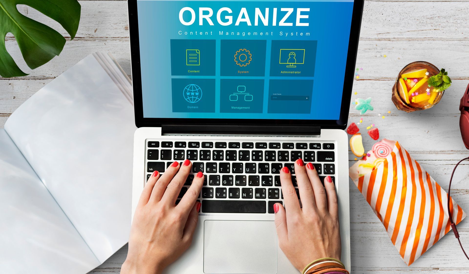 A woman is typing on a laptop computer with the word organize on the screen.