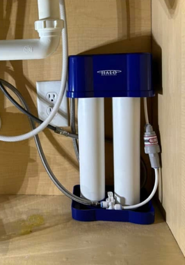 Black River Plumbing & Gas - Under a kitchen sink, plumbing pipes and fixtures: drains, pipes, and connections.