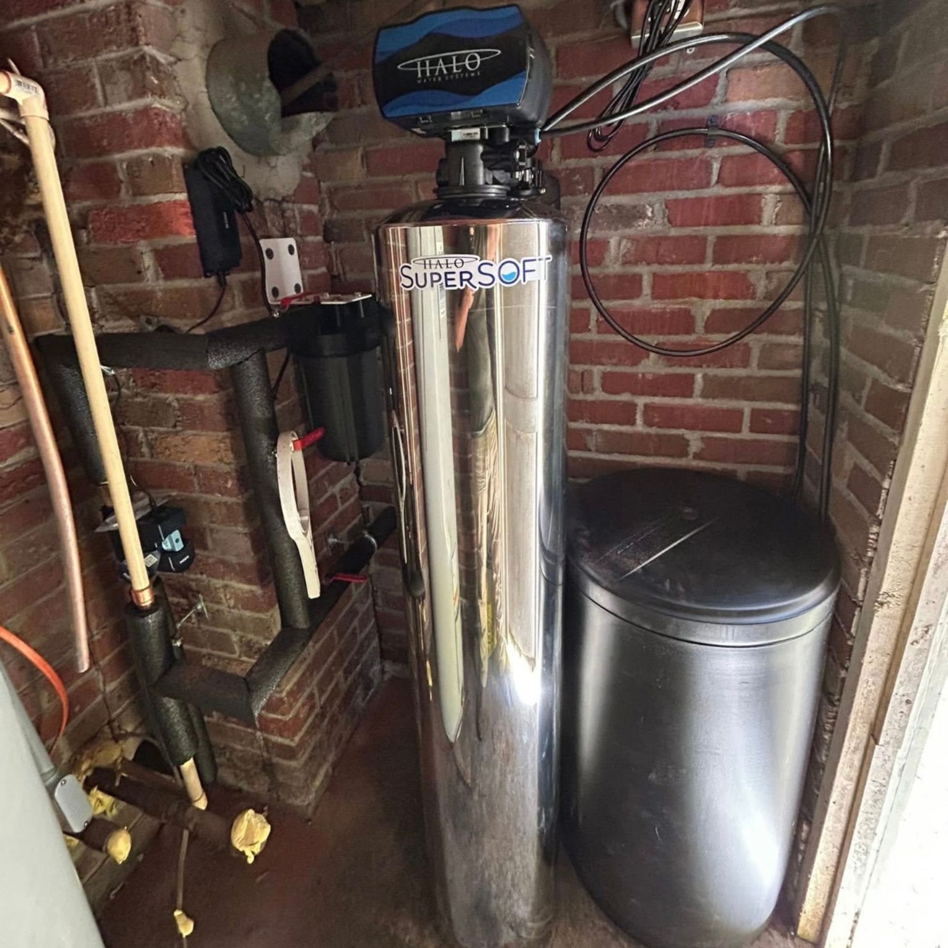 Black River Plumbing & Gas LLC - Water Black River Plumbing & Gas LLC -softener system in brick-walled.
