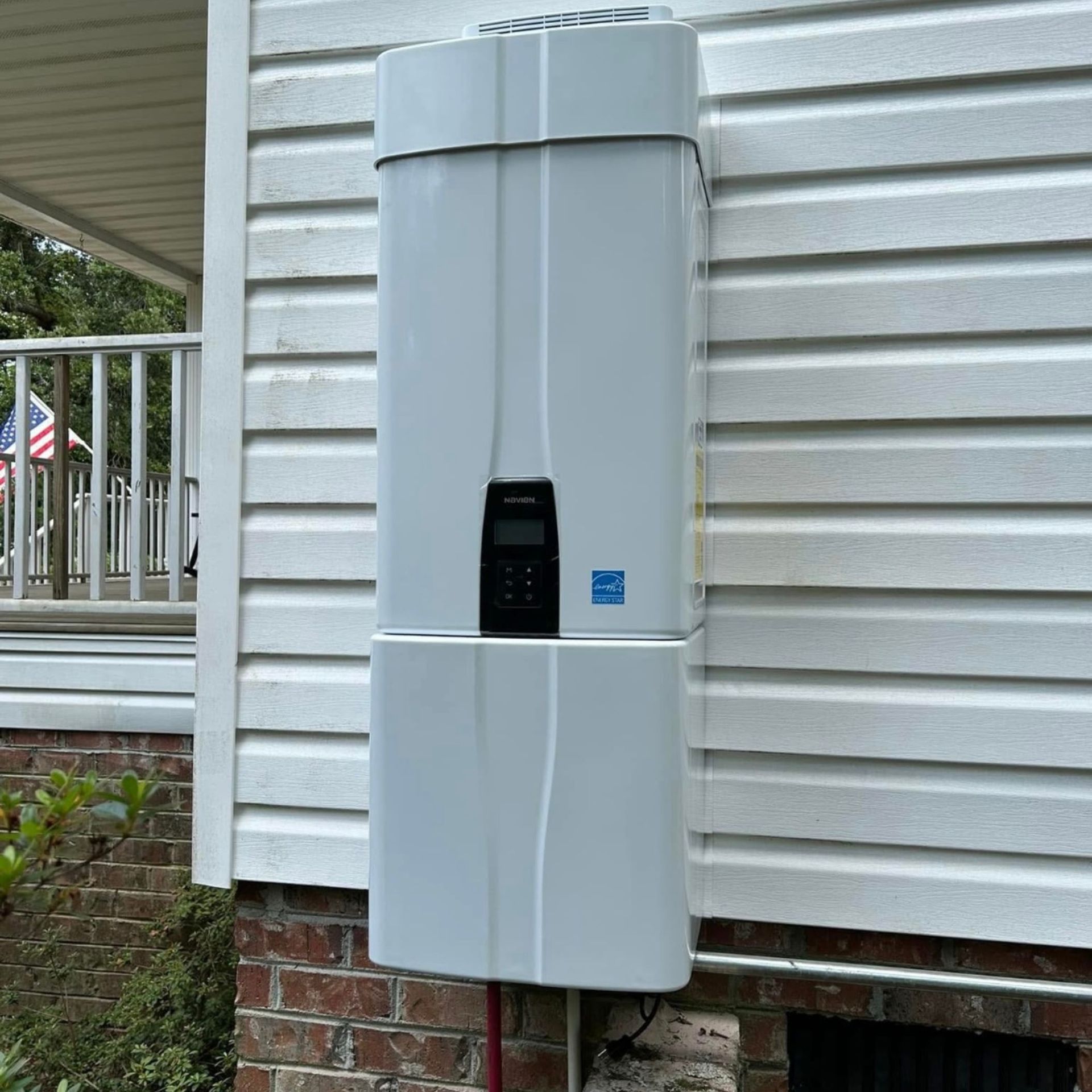 Black River Plumbing & Gas LLC - Solar energy storage unit mounted on a white-sided house.