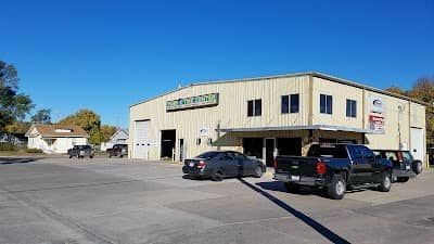 A large building with a lot of cars parked in front of it.