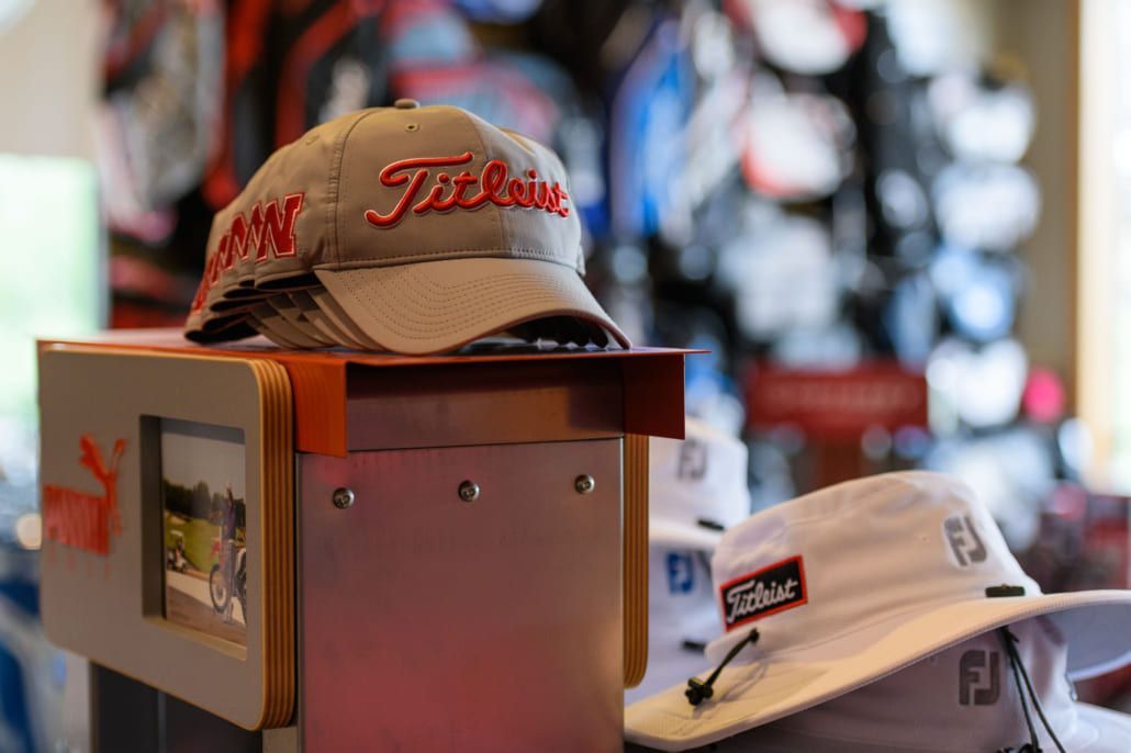 A golf hat is sitting on top of a display case in a store.