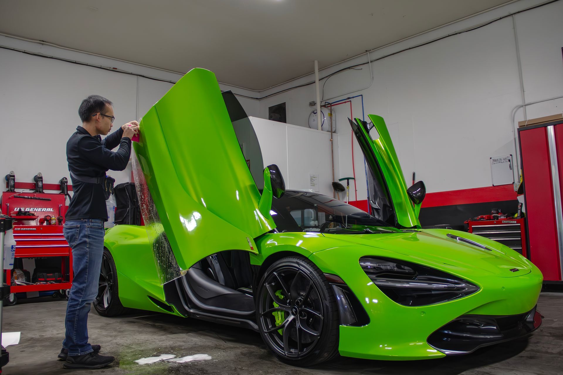 mclaren green sports car getting paint protection film