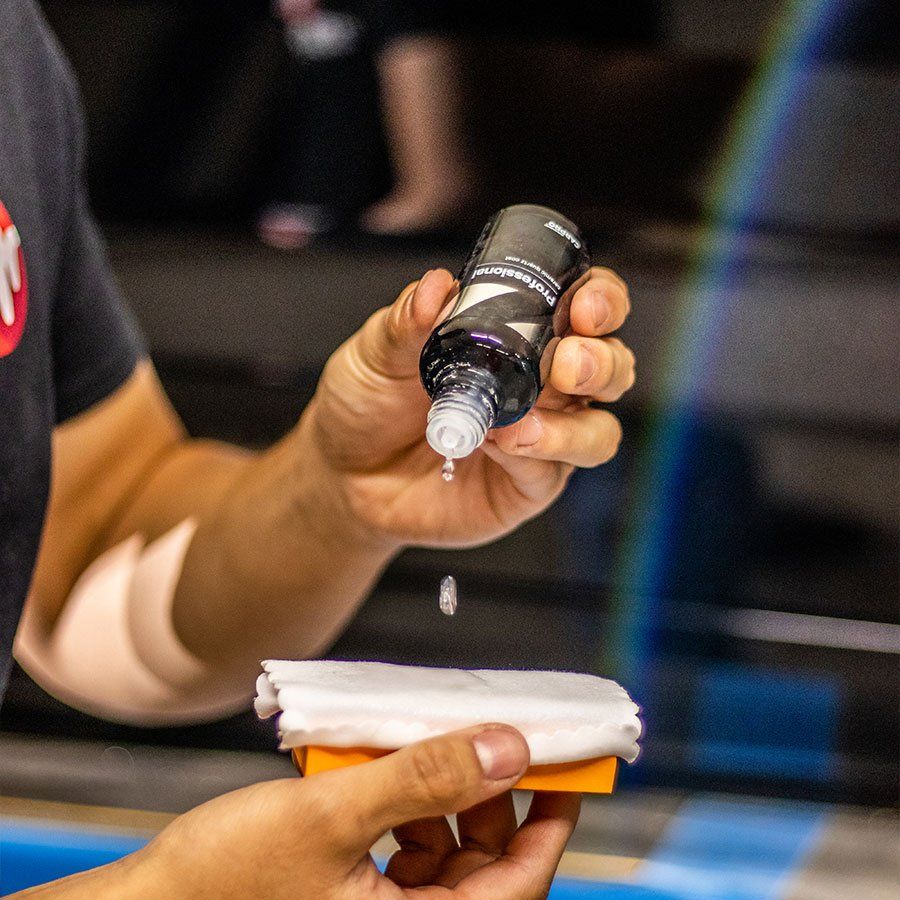 a person is holding a bottle of liquid in their hand