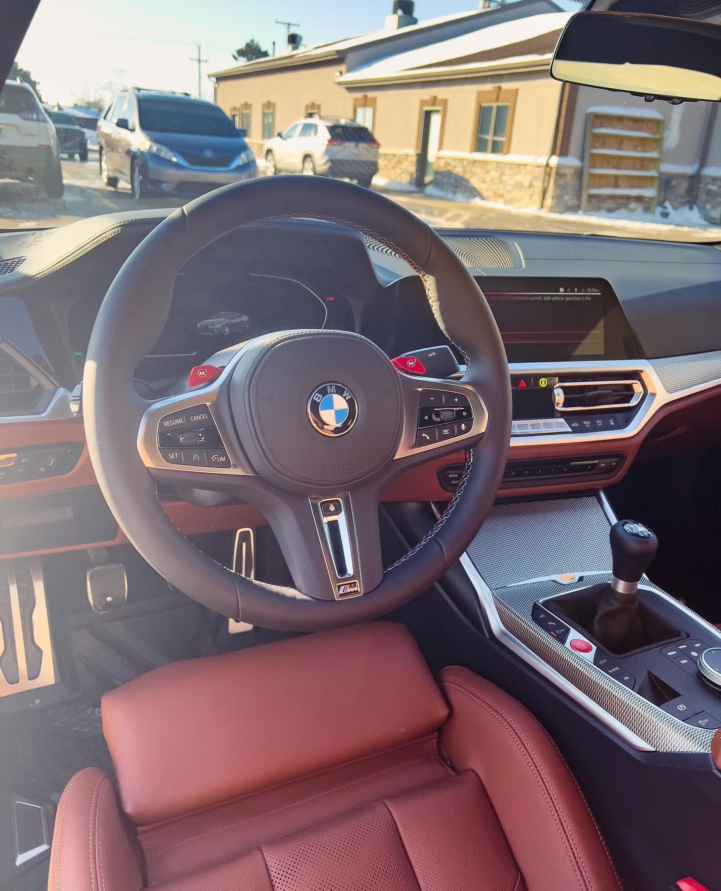 the inside of a bmw with a steering wheel