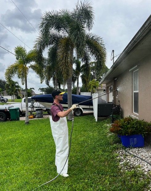 Man Pressure Washing House