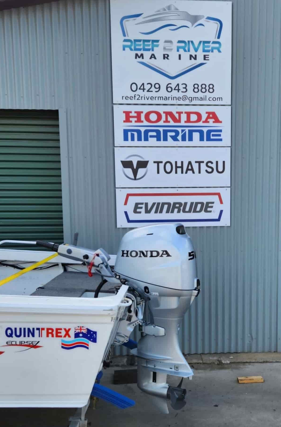 A Boat is Tied to a Trailer in Front of a Sign for Reef River Marine — Reef 2 River Marine in Proserpine, QLD