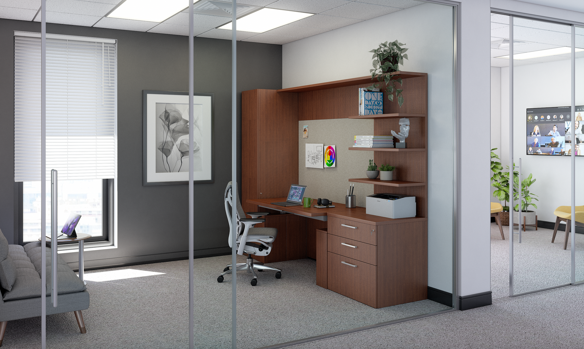 Office with desk, shelving, computer, and chair. Gray walls with window and glass-walled conference room visible.