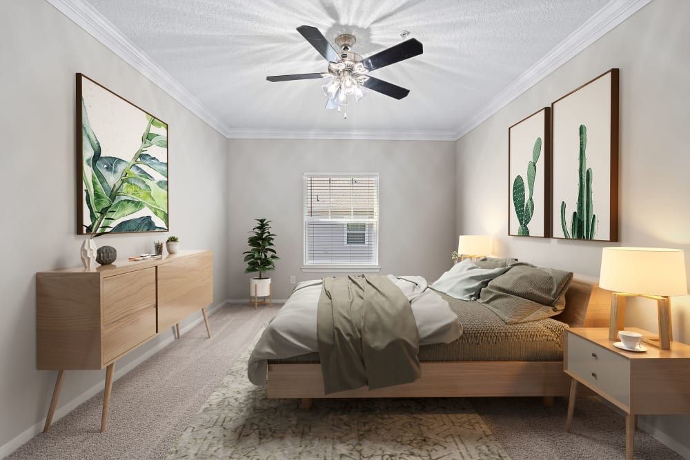 Apartment bedroom with a bed, nightstand, dresser, and ceiling fan at Marquis at Silverton in Cary, NC.