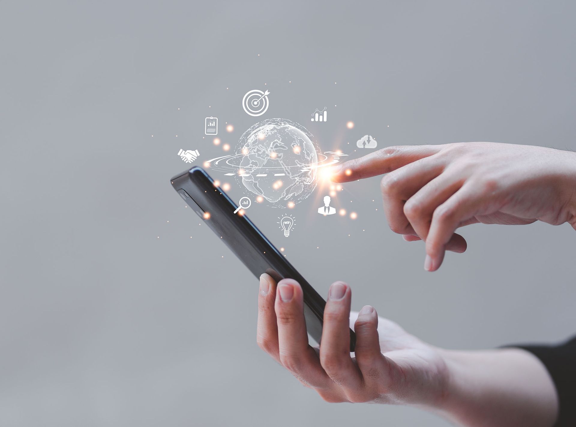 Person holding a smartphone with digital globe and icons overlaid, finger touching screen.