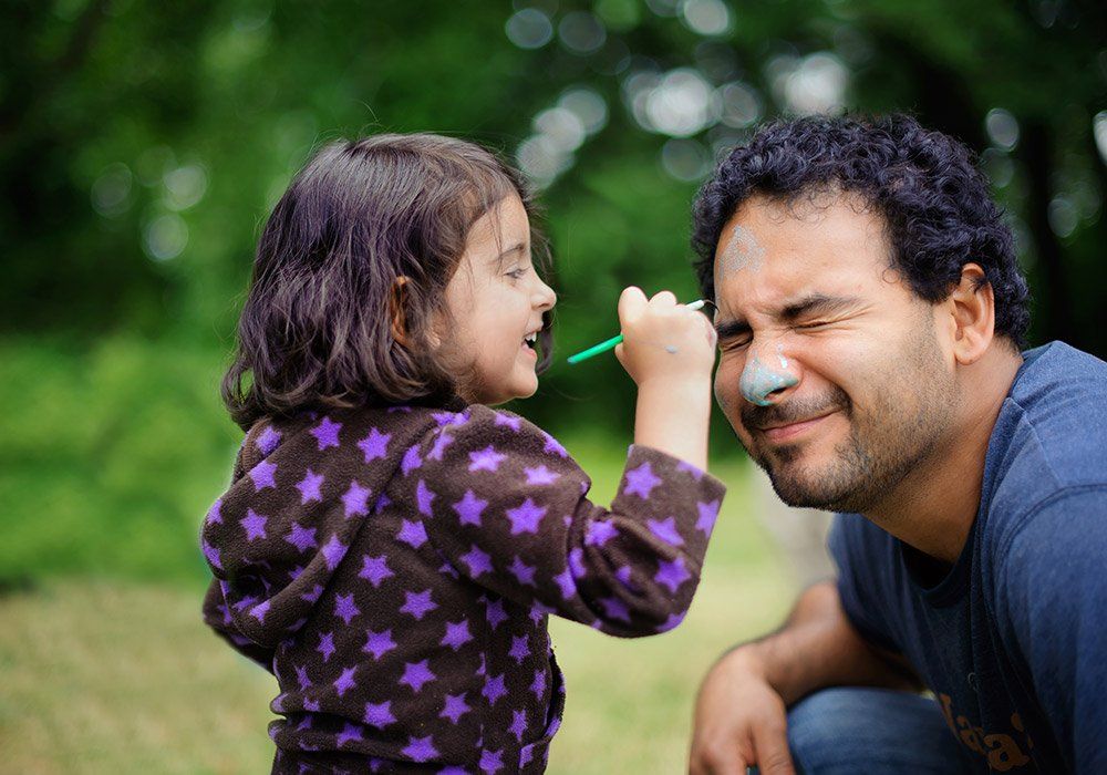 Kid Painting Her Face Dad — Milwaukee, WI — The Parenting Network