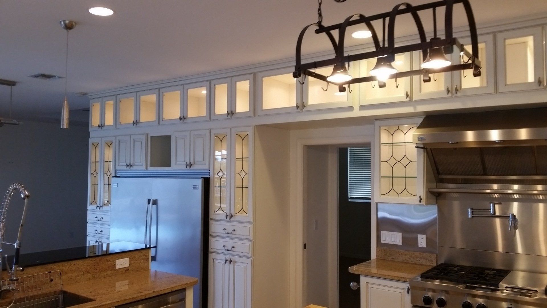 Kitchen with white cabinets, stainless steel appliances, and granite countertops.