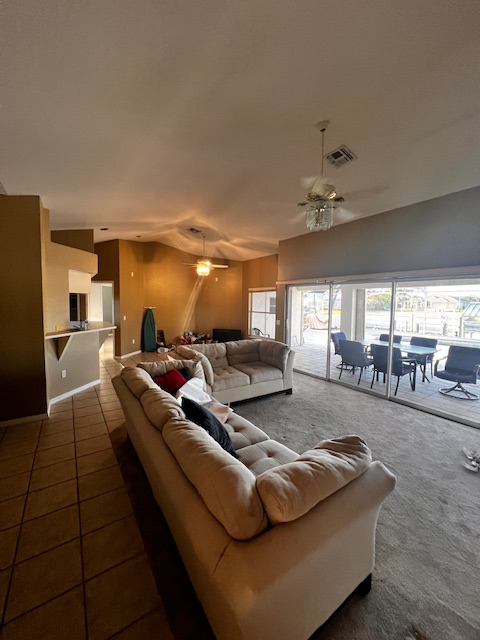 Kitchen with white cabinets, light blue walls, and a counter looking out to a patio.