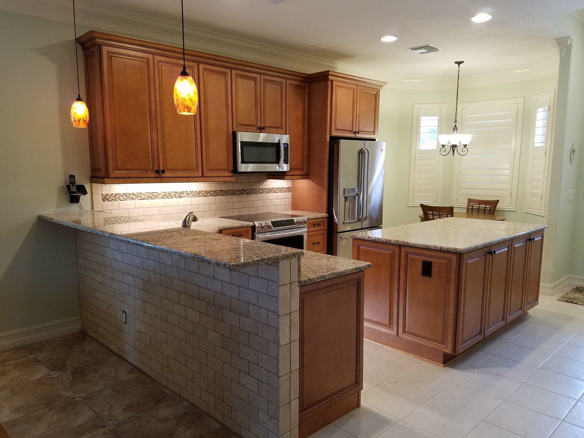 Kitchen with wooden cabinets, granite countertops, and a large island.