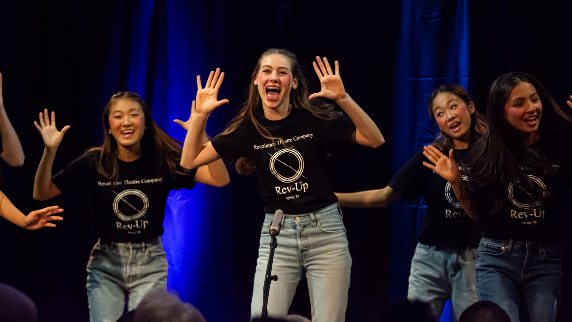 A group of young women are dancing on a stage.