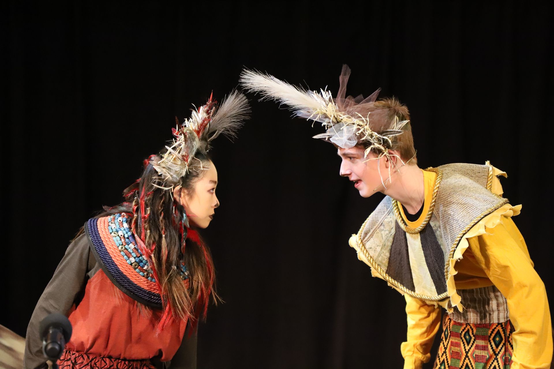 A man and a woman are standing next to each other on a stage.