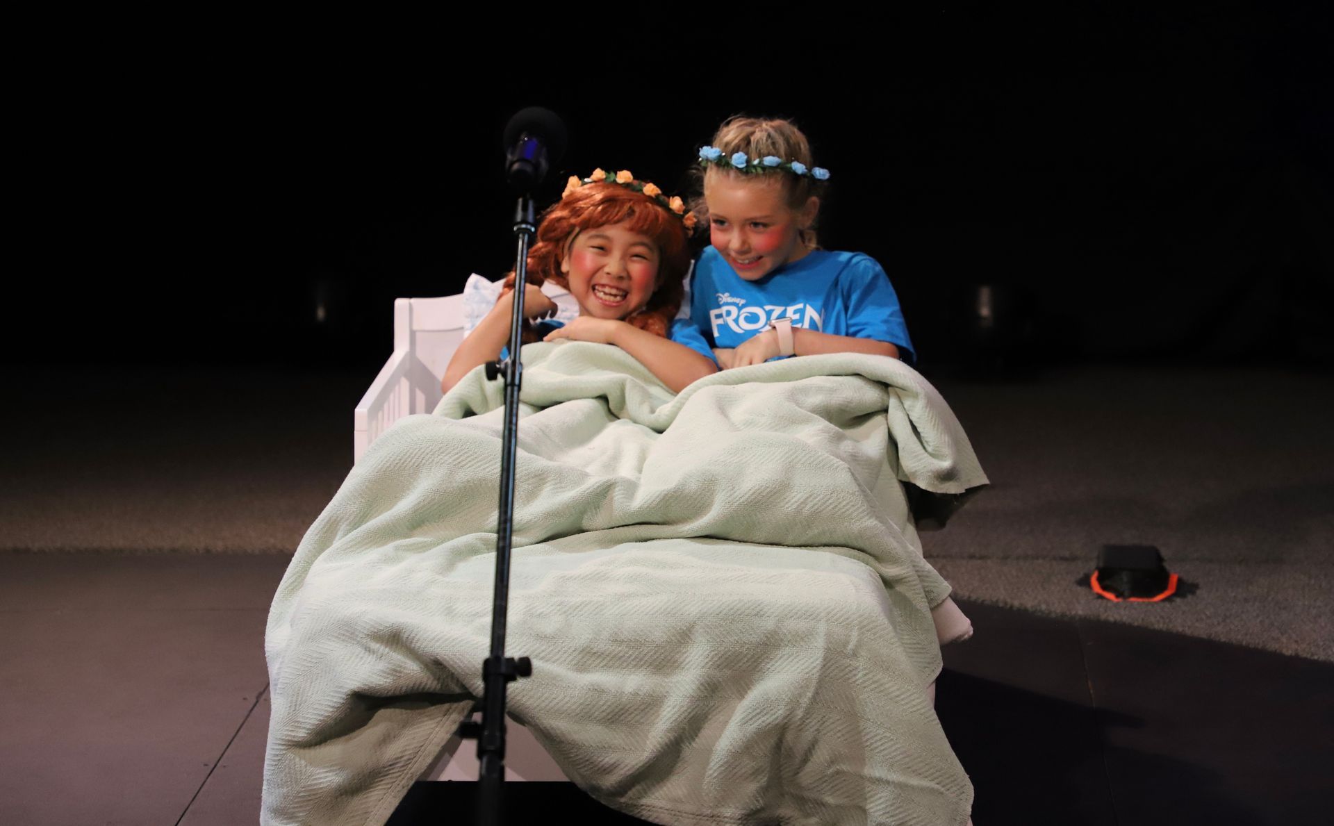 A girl in a blue shirt with the word frozen on it