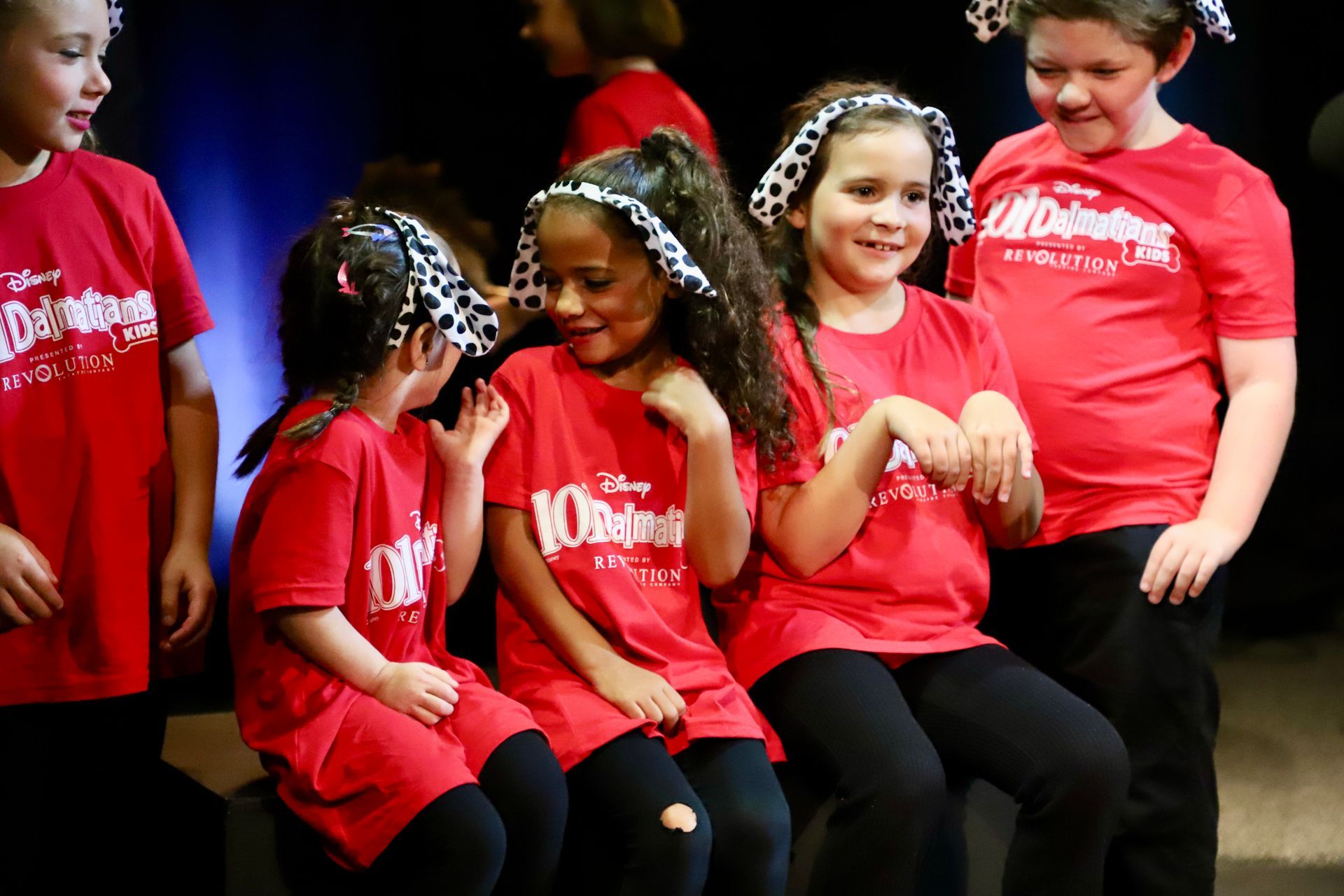 A group of children wearing red shirts with the word disney on them