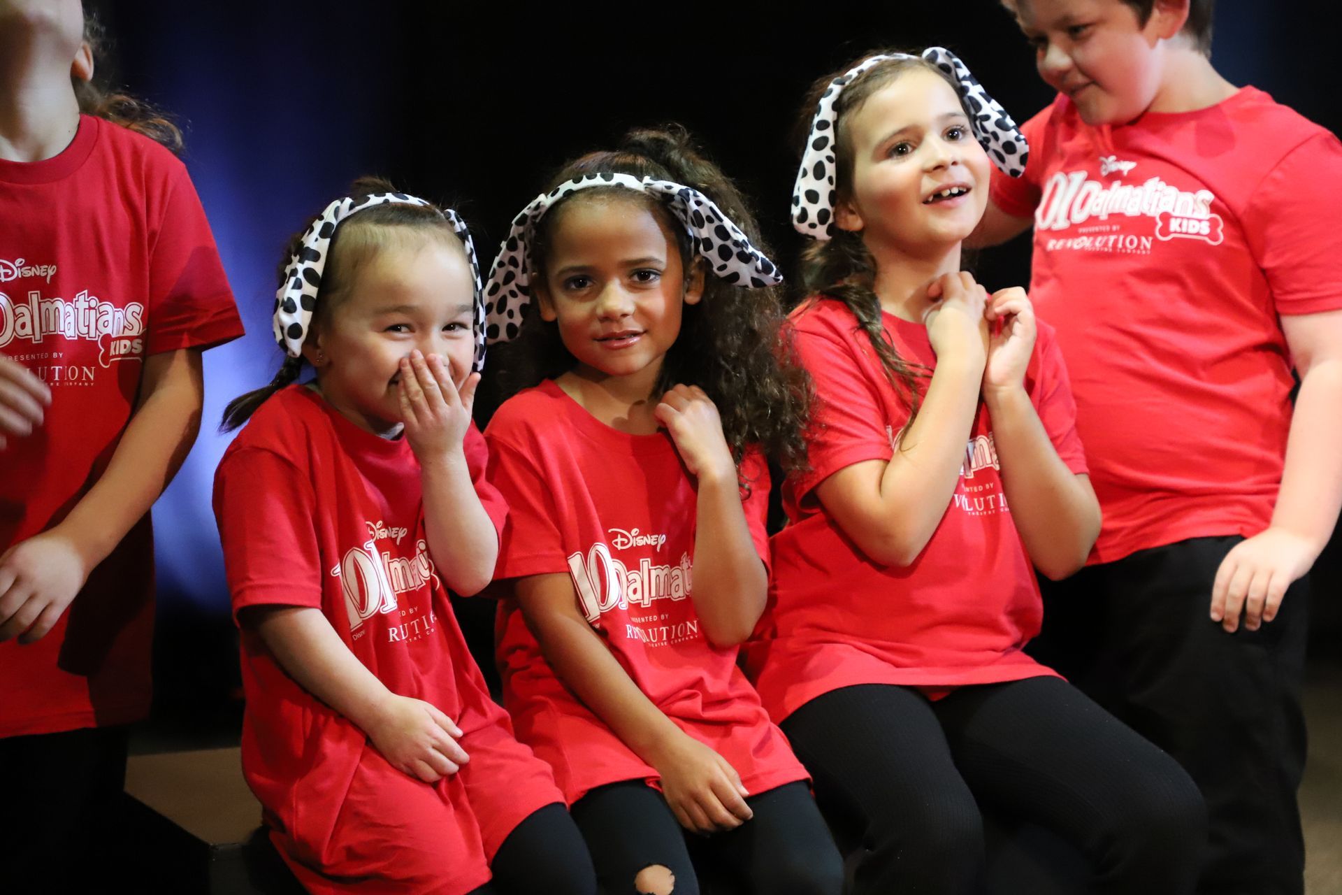 A group of children wearing red shirts with the word disney on them