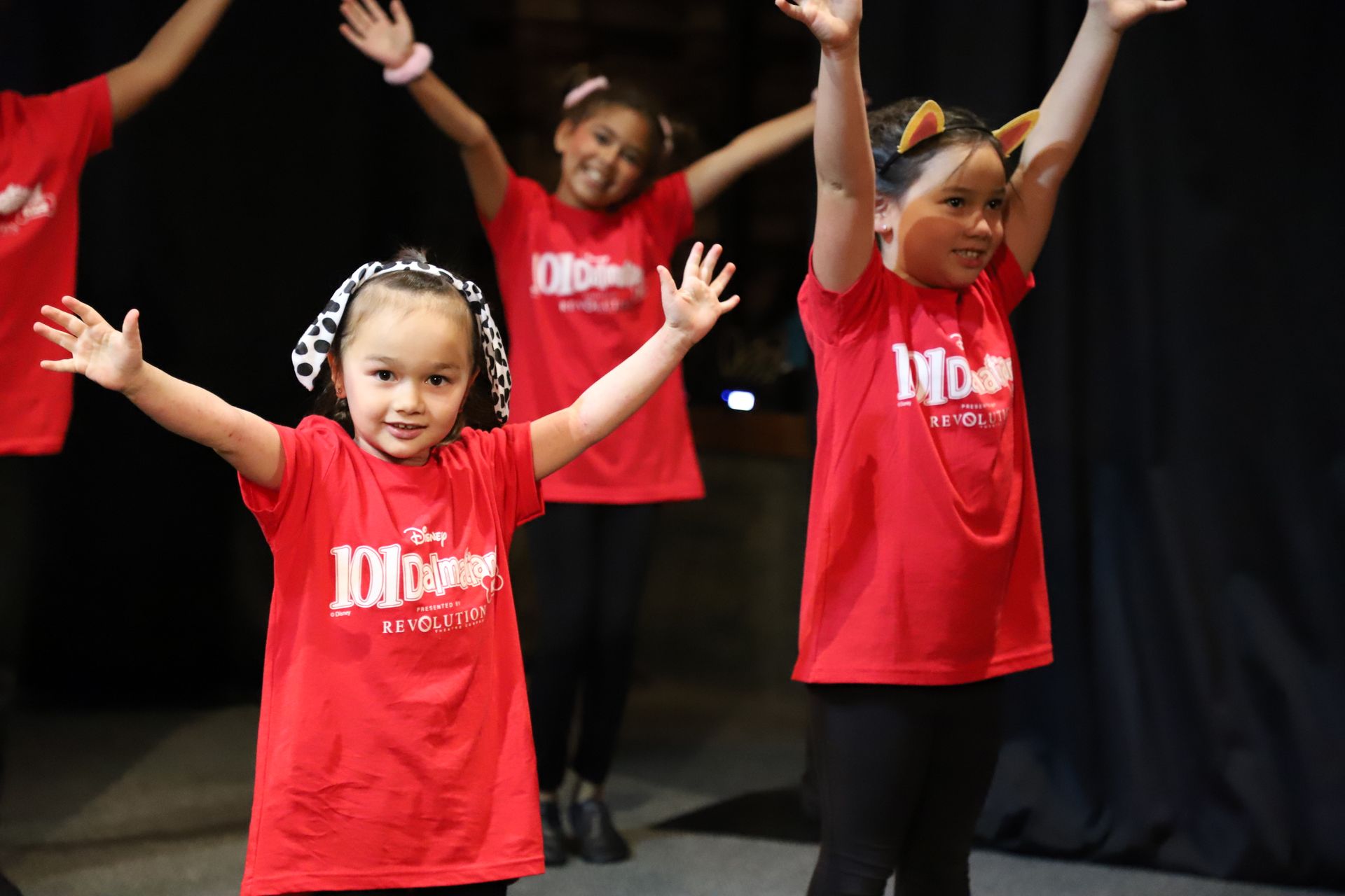 A group of young girls are wearing red shirts that say 101 dance