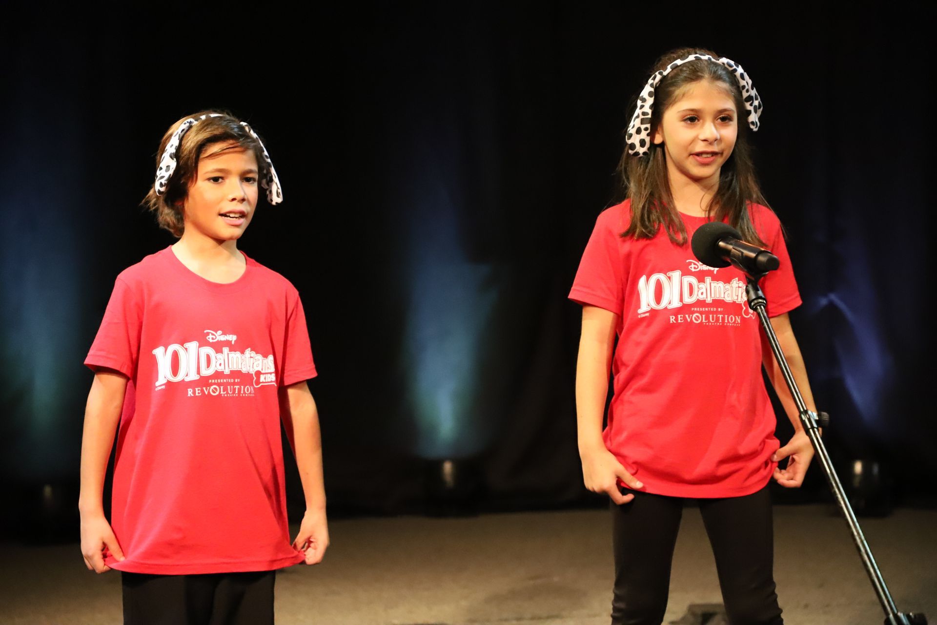 Two young girls wearing red shirts that say 101 on them