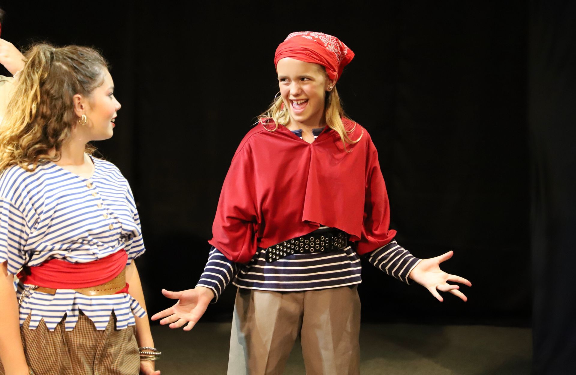 One girl dressed as a pirate is singing
