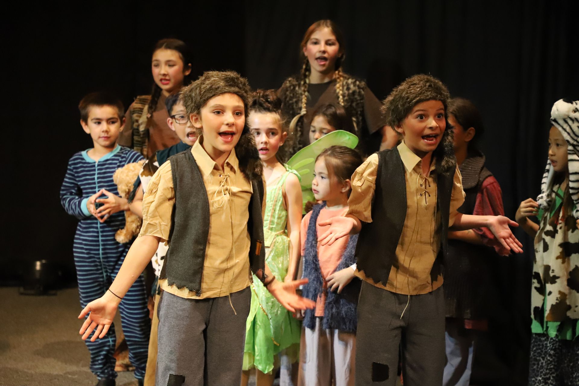 A group of children are standing on a stage.