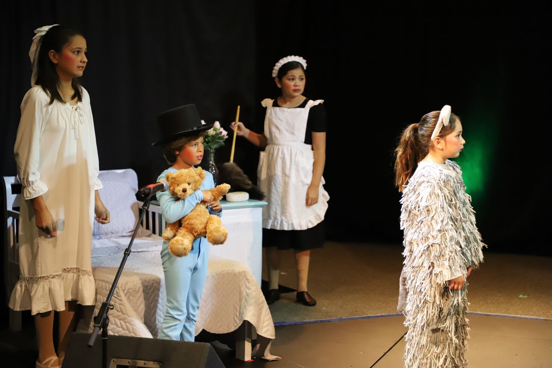 A group of children are playing a play on a stage.