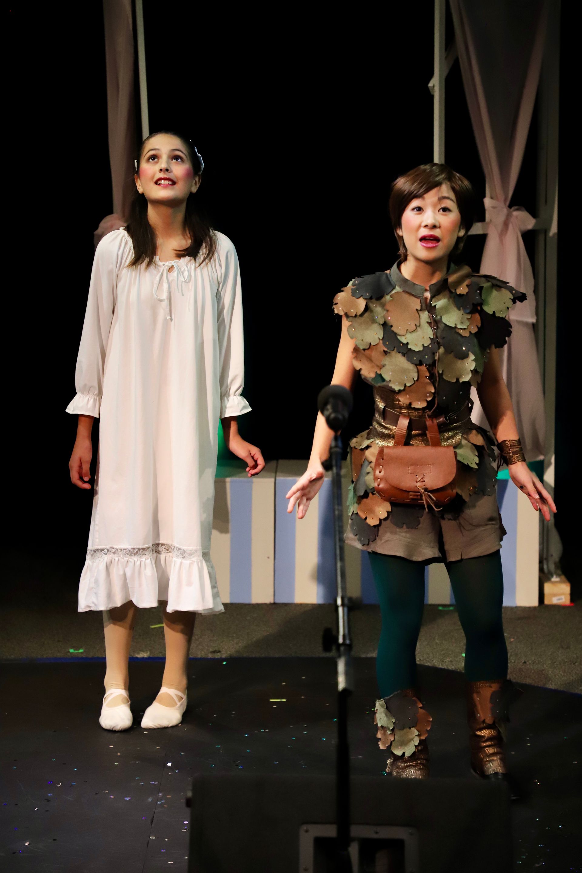 Two women are standing next to each other on a stage.