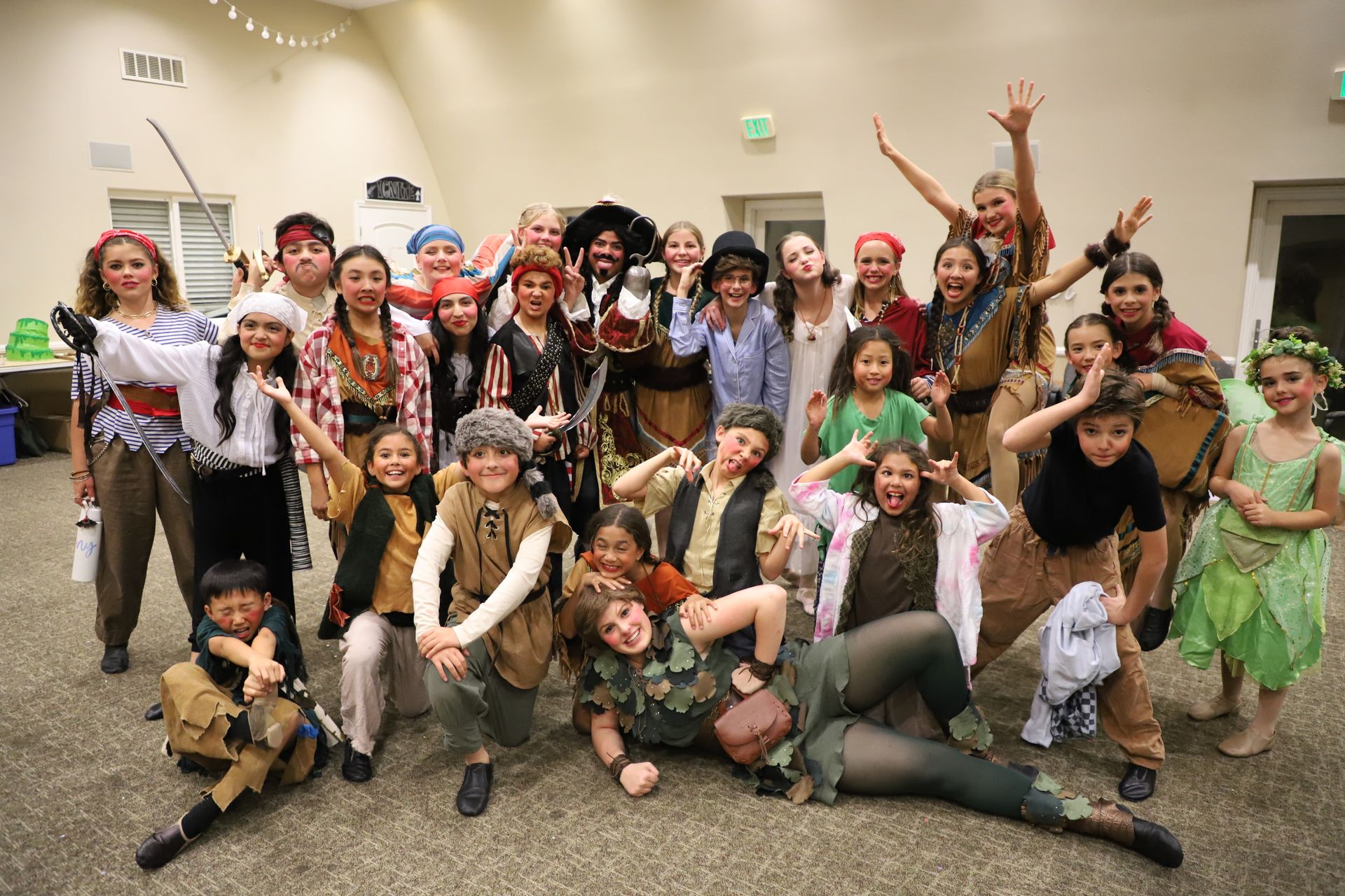 A group of children dressed in pirate costumes are posing for a picture.