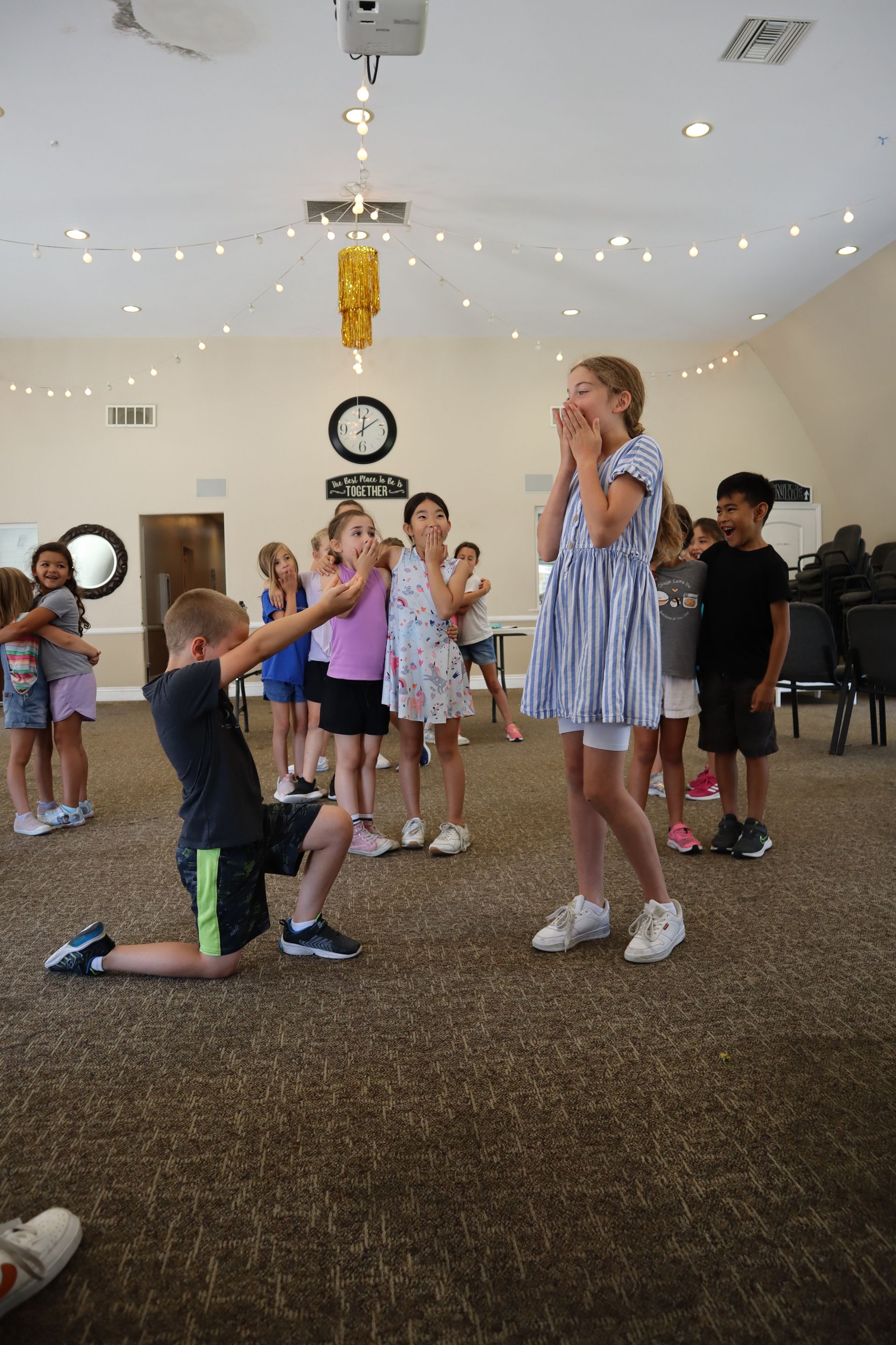 A group of children are playing a game in a room.
