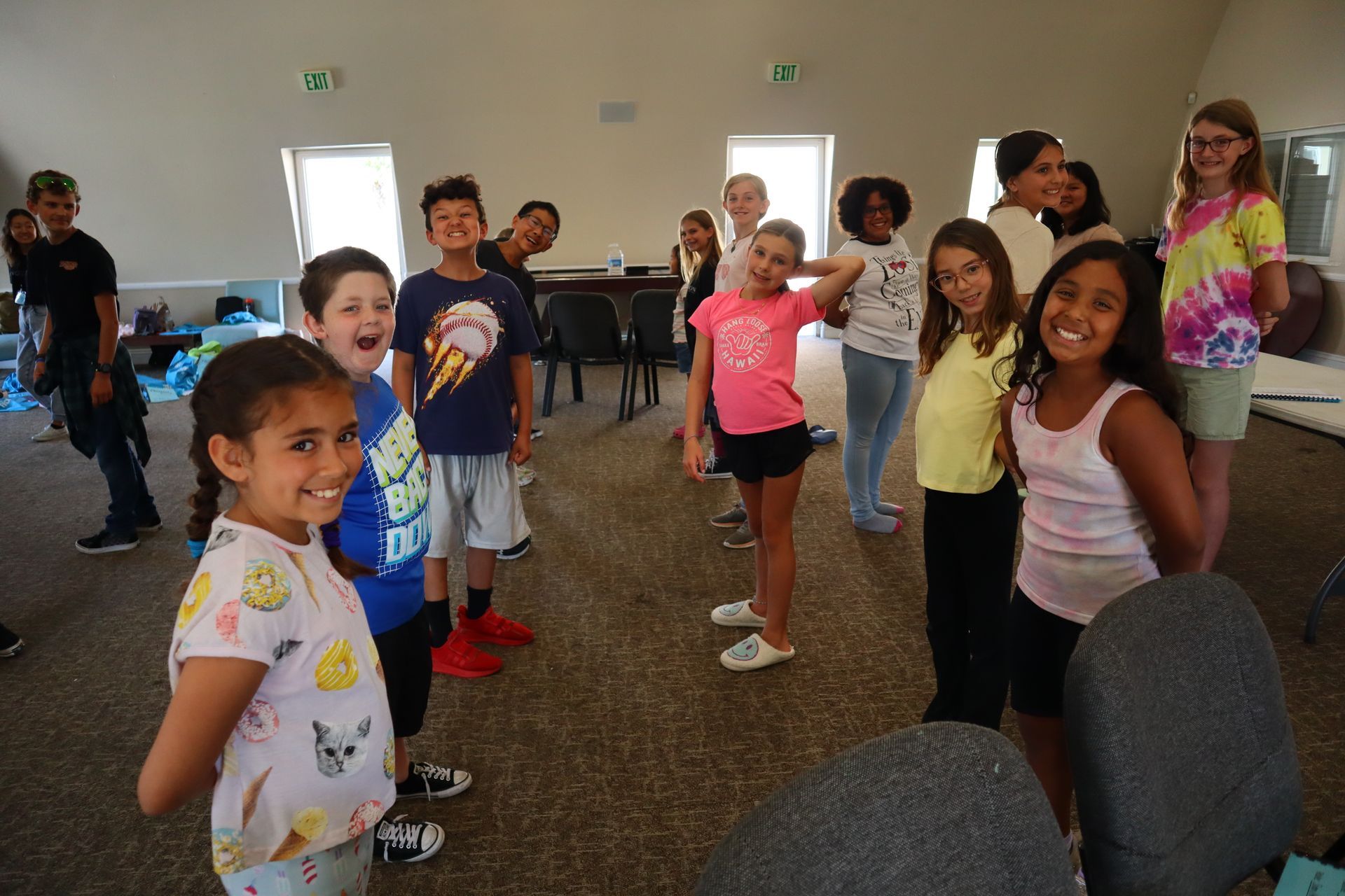 A group of children are posing for a picture in a room.