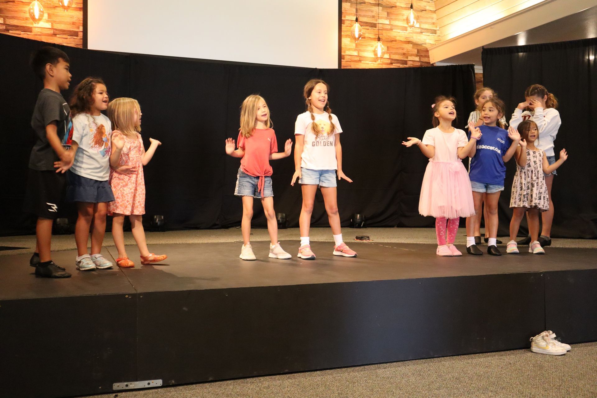 A group of children are standing on a stage.