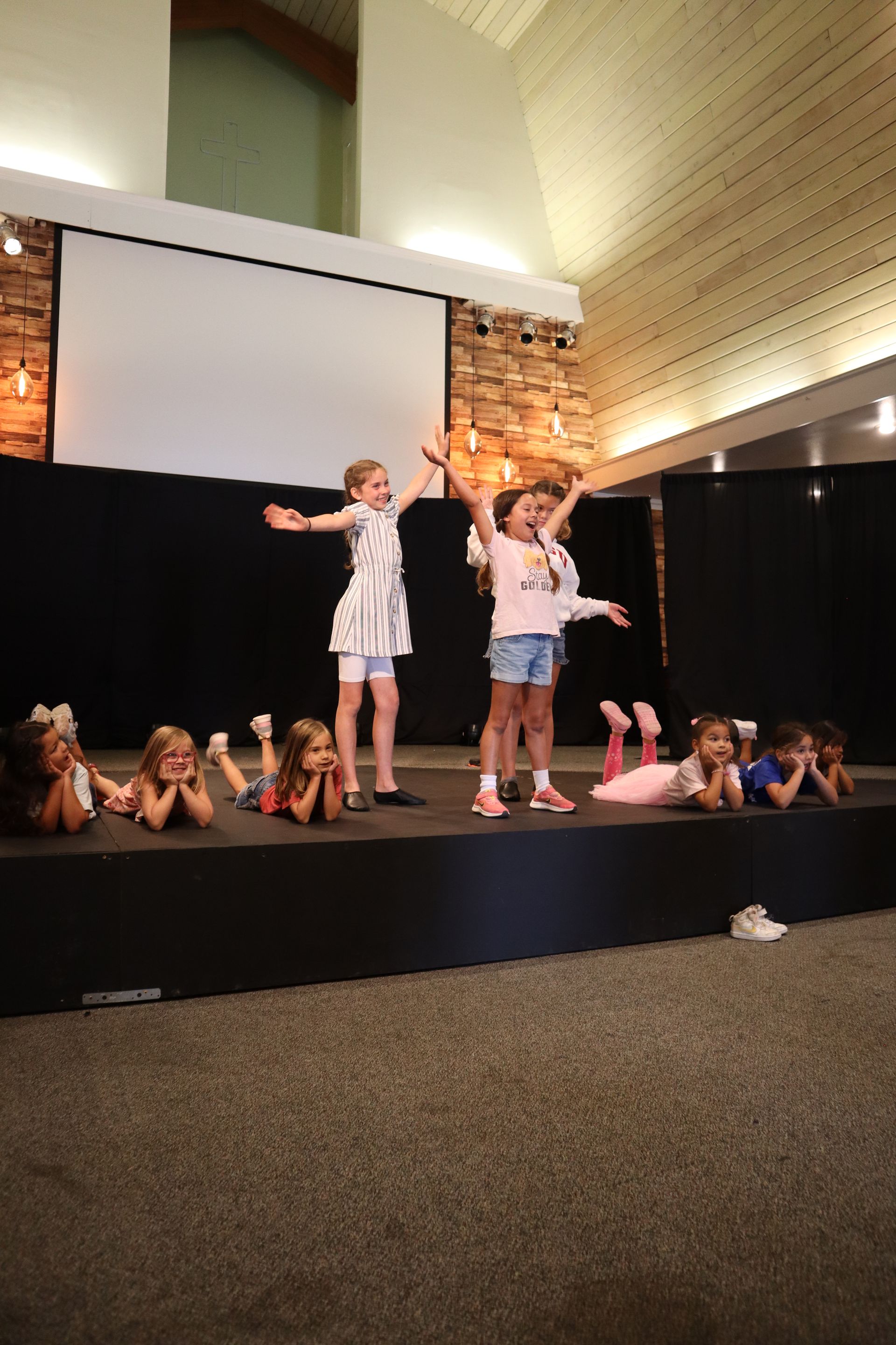 A group of young girls are standing on a stage.