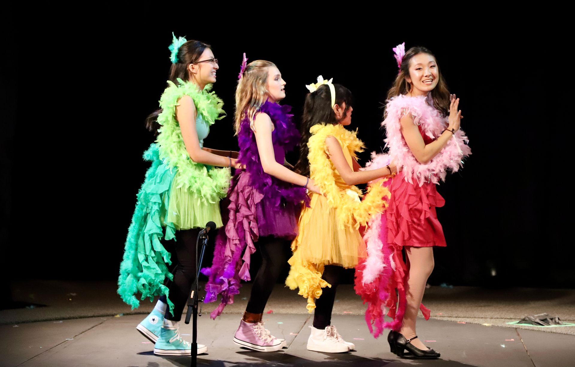 A group of young girls are standing next to each other on a stage.
