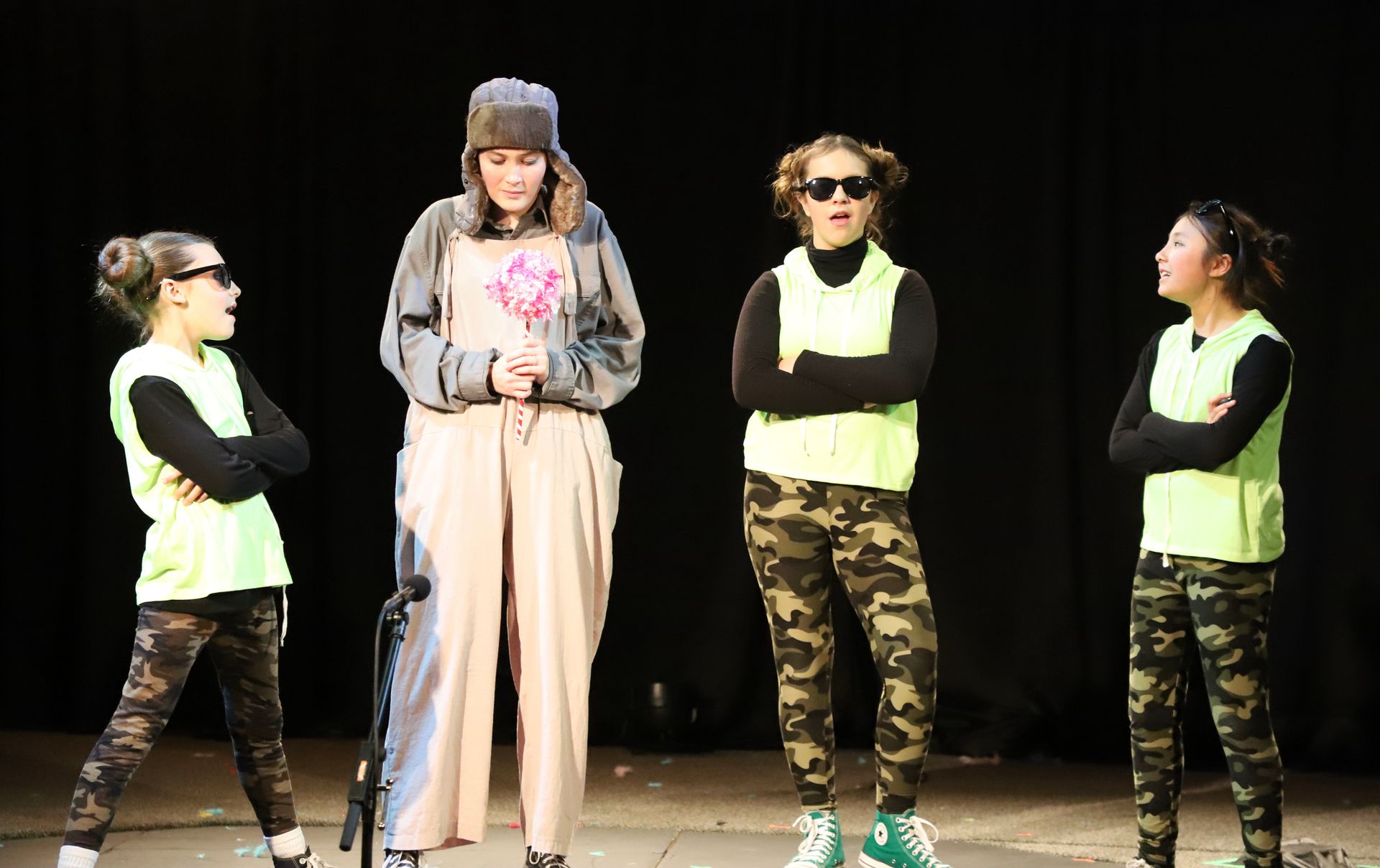 A group of young girls are standing on a stage.