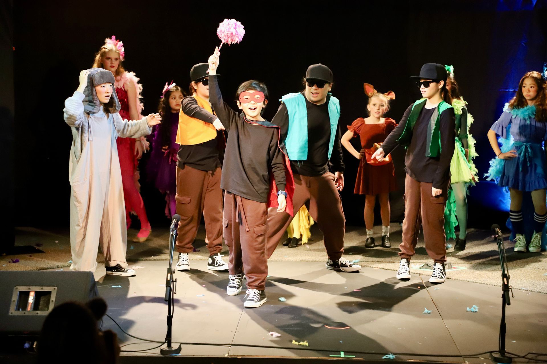 A group of young people are dancing on a stage.
