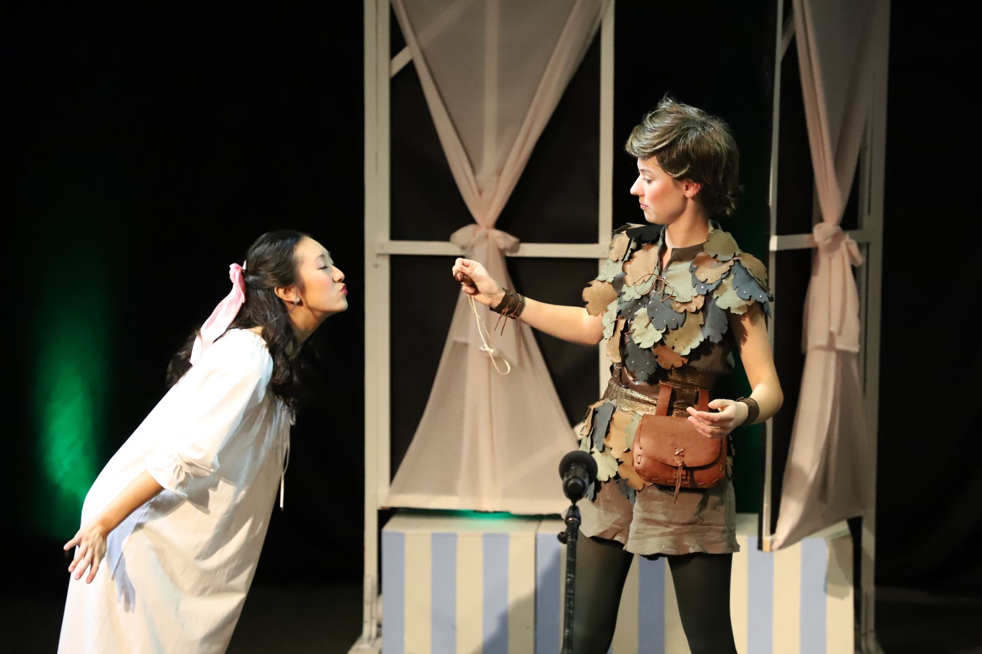 A man and a woman are standing next to each other on a stage.