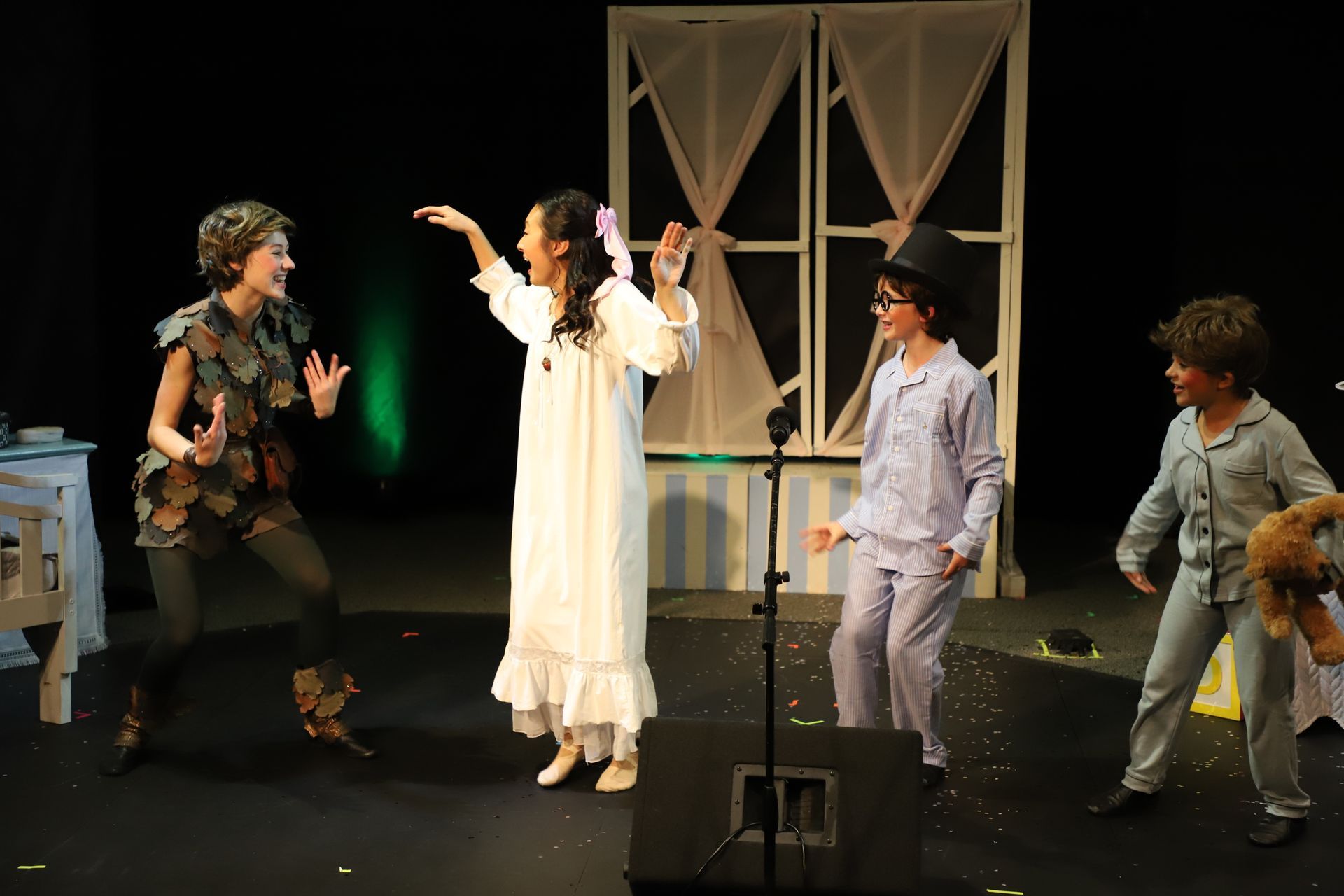 A group of children are playing peter pan on a stage