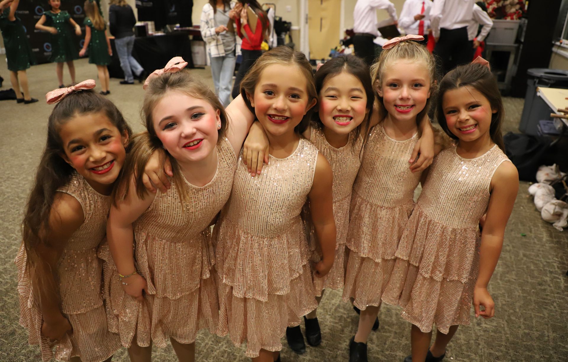 A group of young girls are posing for a picture together.