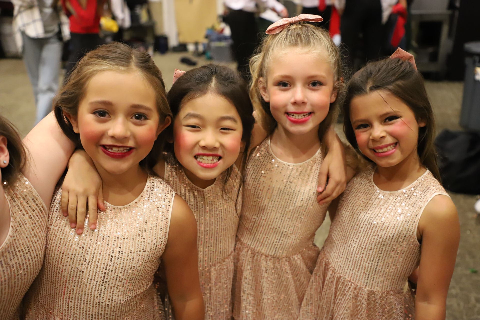 A group of young girls are posing for a picture together.